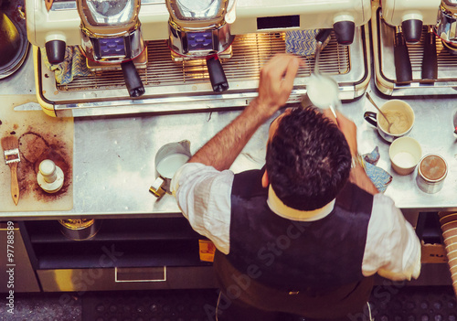 Fotografie, Obraz Barista and coffee machines at the bar, vintage filter applied