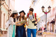 © Sergey Novikov - Happy young women and guy with camera as tourists