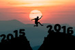 Silhouette man jumps to the New Year 2016 with sunrise