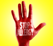 Stop Allergy Written On Hand With Yellow Background