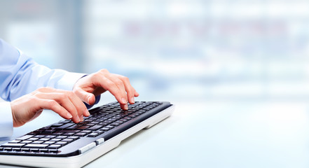 Fototapete - Hands with a computer keyboard.