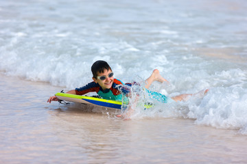 Canvas Print - Boy swimming on boogie board