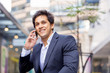 © Sergey Nivens - Portrait of confident businessman with mobile phone outdoors