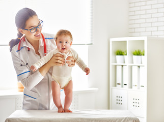 Wall Mural - doctor examining a baby