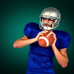 Canvas Print - American football player holding ball