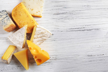 Wall Mural - Different kinds of cheese on white wooden background, copy space