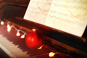 Sticker - Piano keys decorated with decoration lights and red ball, close up