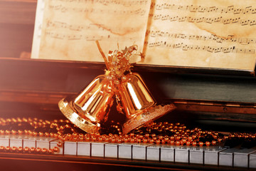 Poster - Piano keys decorated with golden Christmas decorations, close up