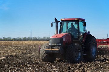 Poster - Red tractor working in the field