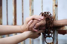 Women Hand Holding Prisoner Hand.