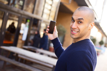 young man holding his phone