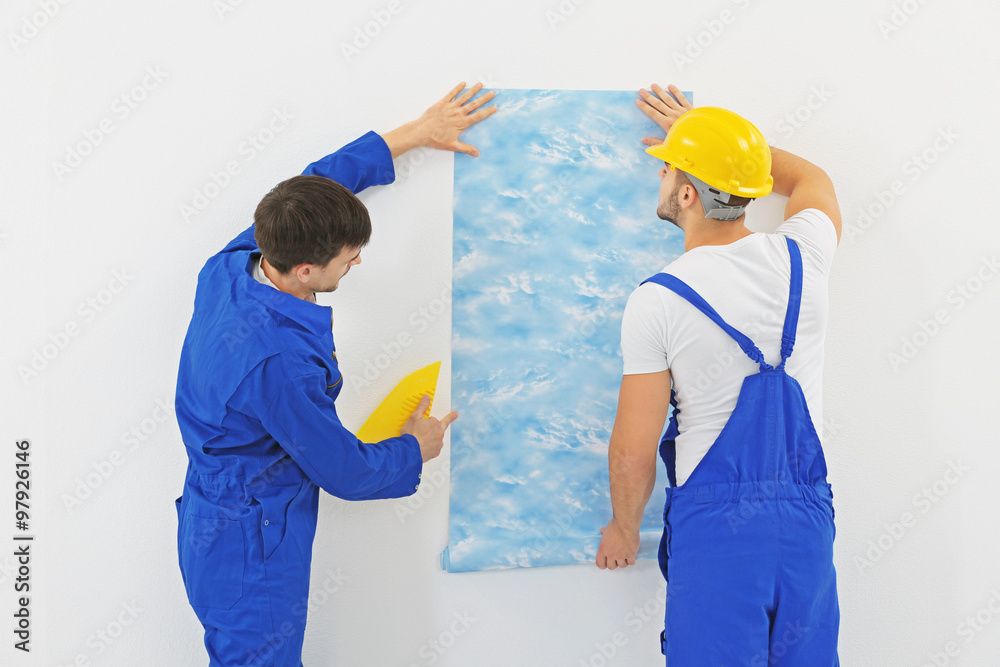 Workers renewing apartment on wall background