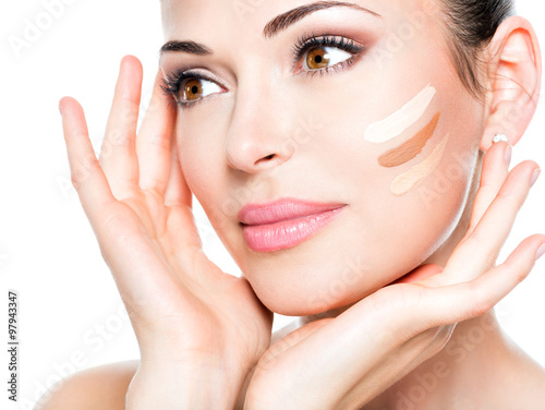 Fotografering Beautiful face of woman with cosmetic foundation on a skin.