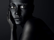 Woman With A Painted Black Skin And Crystals On The Brows. Black