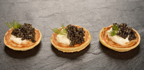 Canvas Print - Mini pancakes with black caviar