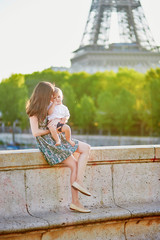 Wall Mural - Beautiful young mother with her adorable in Paris, France