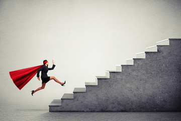 Sticker - superwoman in red cloar running up stairs