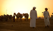 Dubai camel racing club sunset silhouettes of camels and people.