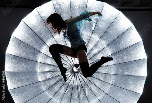 Fototapeta do kuchni Jumping woman's silhouette over bright background.