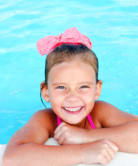 Wall Mural - Cute smiling little girl in swimming pool