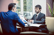 © de Art - two businessman business partner are negotiating in the cafe