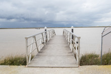 Wooden Pier River On A Cloudy Day