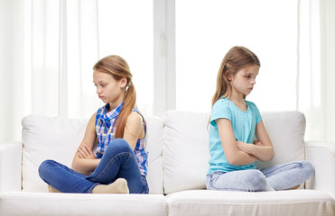 Canvas Print - quarreled little girls sitting on sofa at home