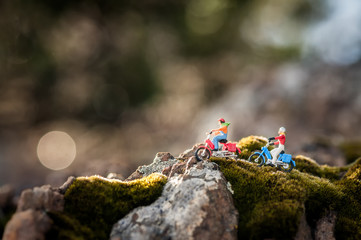 Two miniature happy riding bikers.