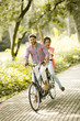 © BGStock72 - Young couple riding on the bicycle