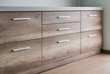 Wooden kitchen drawers with silver handles