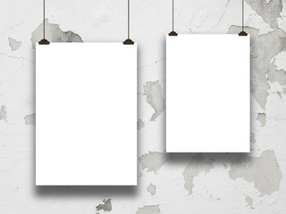 Two asymmetrical paper sheet frames on cracked and stained concrete wall background 