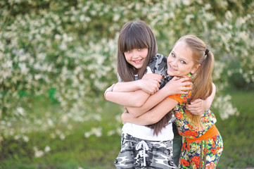 portrait of two girls of girlfriends on a summer nature