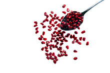 Pomegranate Seeds On White And Spoon