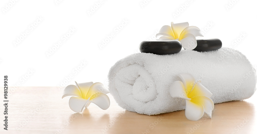 Spa stones with towel and plumeria, isolated on white