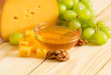 Wall Mural - Still life of cheese, honey, walnuts and grapes