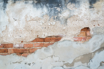 Old bricks texture covered with rough and dirty concrete backgro