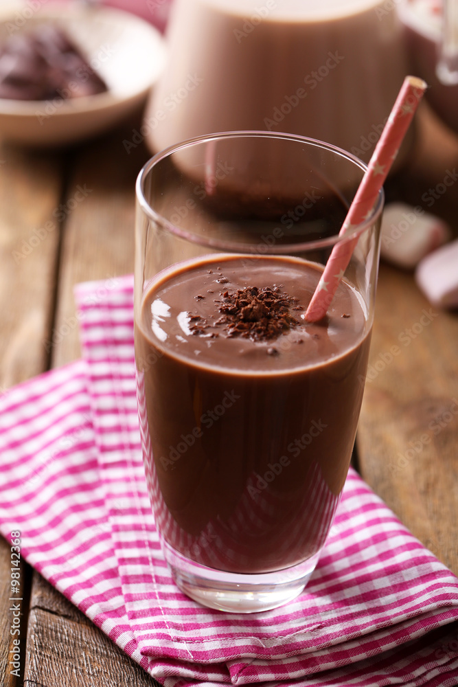 Glass of chocolate milk on table close-up