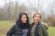 © fabio lamanna - Two young women talking, smiling and having fun outdoors