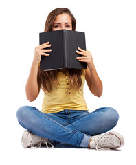 Wall Mural - young smart woman behind a book isolated on white