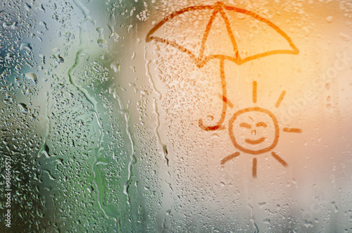 Fotografie, Obraz draw sun holding umbella on natural water drops glass window bac