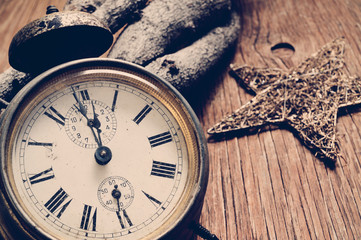 Sticker - old alarm clock and star on a rustic wooden surface