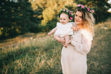 Happy family! Mother and child girl in a summer walk in nature. 