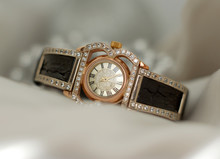 Beautiful Old Vintage Gold Watches With Sparkling Gem Stones On A Soft Bokeh Background