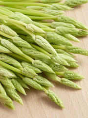 Wall Mural - Fresh Asparagus Spears on Wooden Background