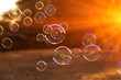 soap bubbles into the sunset , blurred background .close-up