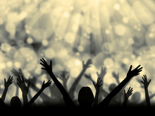Silhouette Of People Raising Hands On A Abstract Light Background