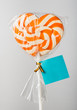 heart shaped colorful candy lollipop with blank note on white ba