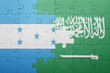 © luzitanija - puzzle with the national flag of saudi arabia and honduras