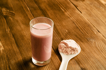 Wall Mural - Protein shake in a glass on a wooden table