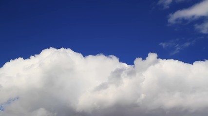 Wall Mural - loop features motion time lapse clouds backed by a deep blue sky.